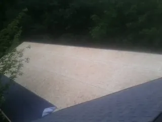 New OSB roof sheathing installed beside an existing shingle roof in Canyon Lake