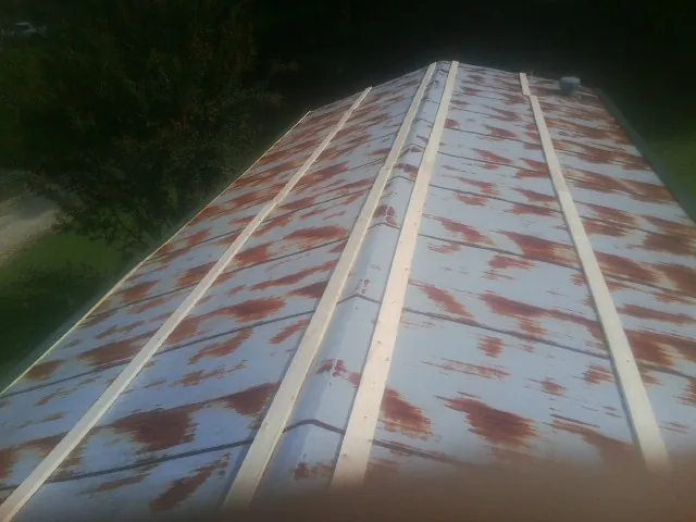 Rusted metal roof panels with new wood purlins before replacement — Storm Damage Roof Repair in Canyon Lake by Roofing Brothers